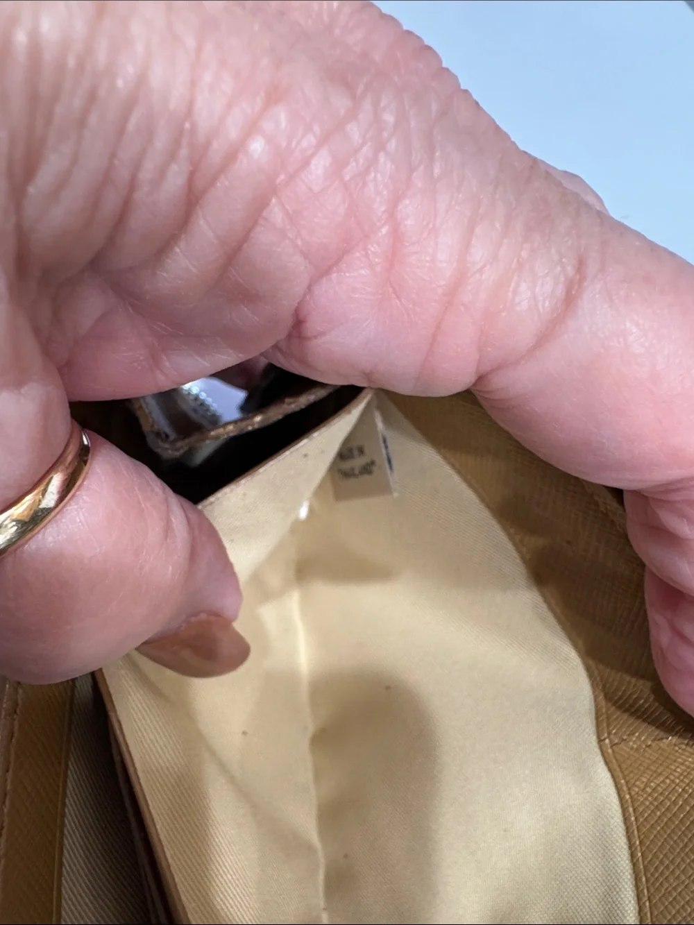 Coach Brown/Tan Signature Zip Wallet with Logo Plaque tags inside.
